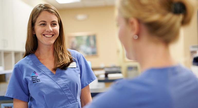 Image of two female nurses talking