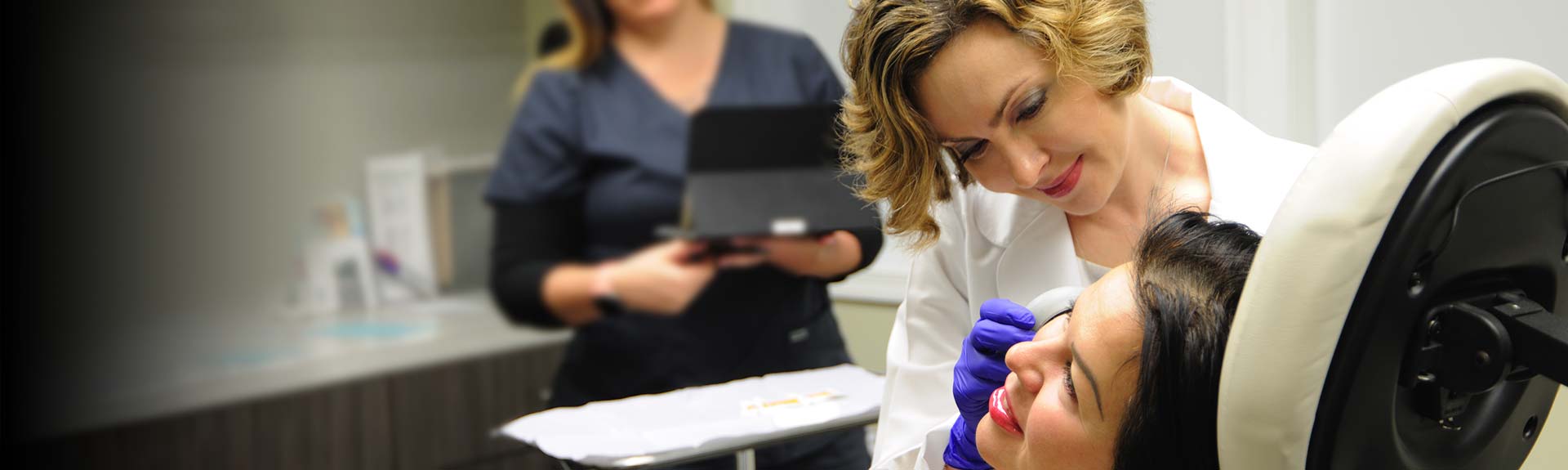 Dermatologist examining patient