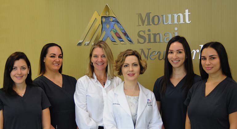 Group of dermatologists in front of the Mount Sinai New York Florida logo