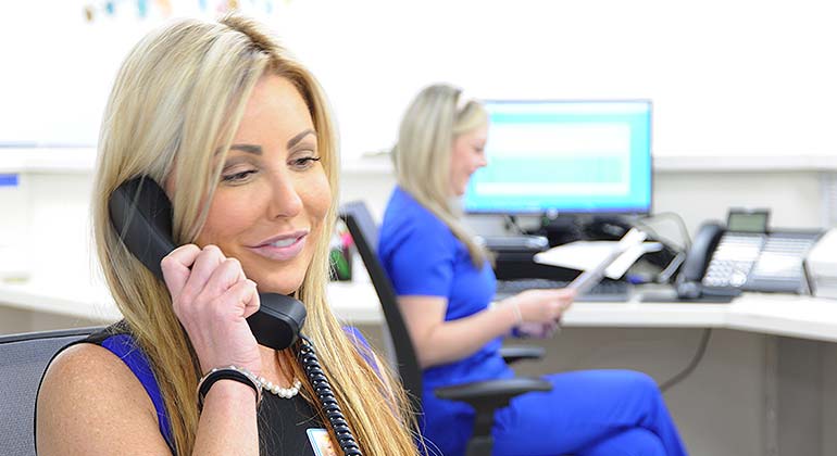 Image of staff member on telephone
