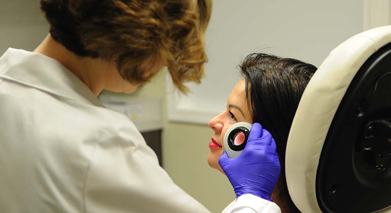 Dermatologist examining patient