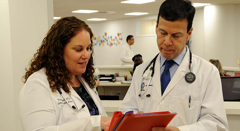 Two doctors discussing a patient report