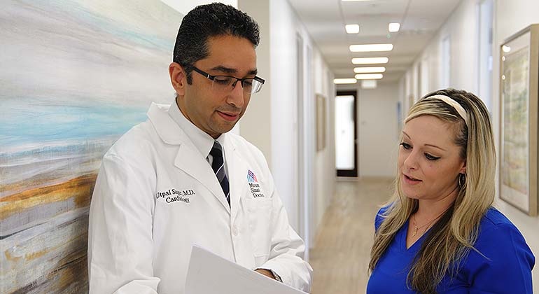 Doctor and nurse looking at report