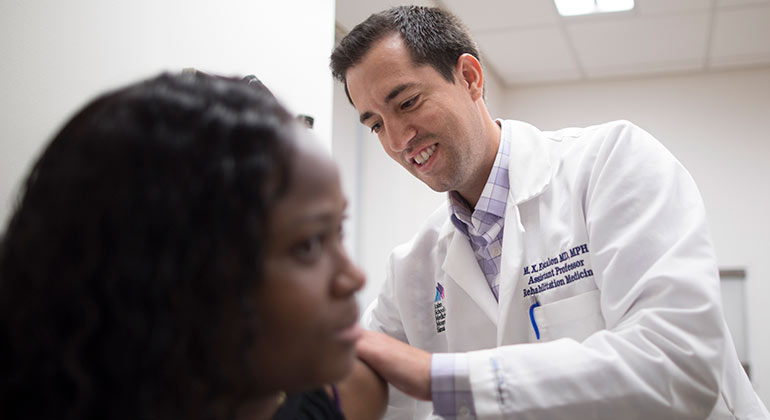Doctor examining patient’s back