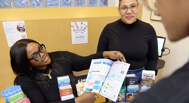 adult showing pamphlet to teen