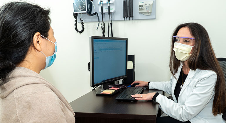 doctor speaking with patient in office