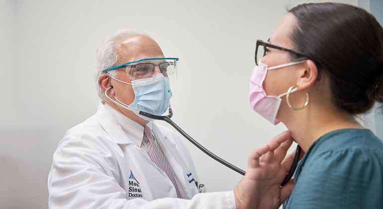 doctor checking patient with stethoscope