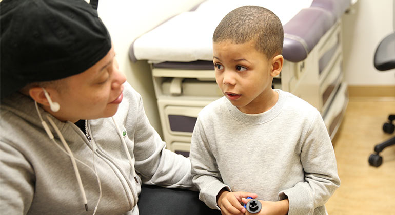 Toddler boy and his mom looking at each other