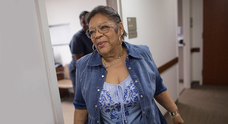 An older woman happily leaving an exam room