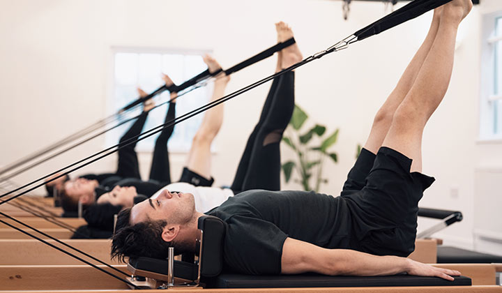 The body of a man and woman in a seated yoga pose