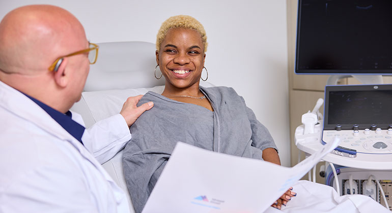 doctor talking to patient in bed