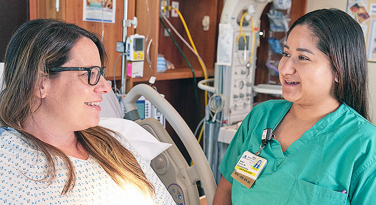 doctor checking in on patient in bed