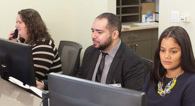 Image of three receptionists at their desk