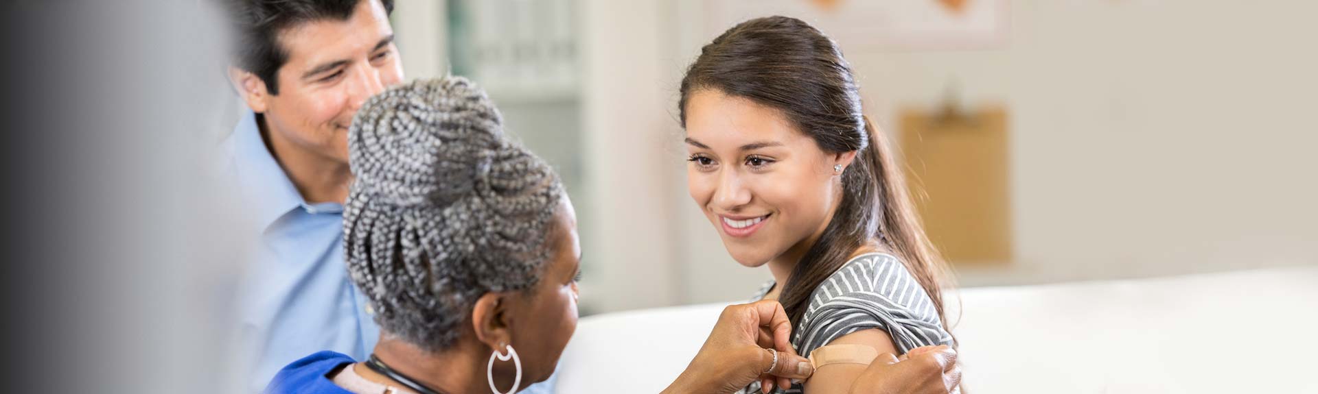 Nurse putting bandage on woman