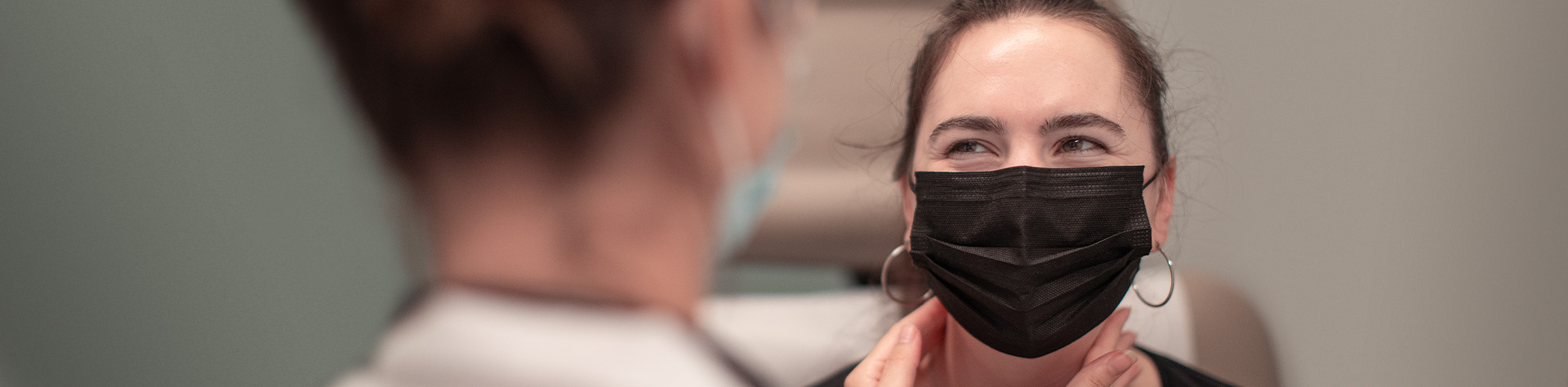 Image of female patient wearing a mask
