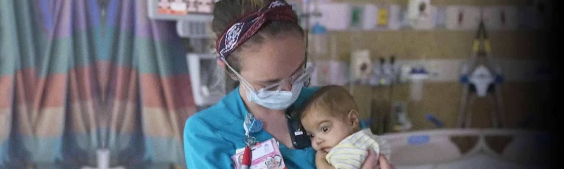 Image of nurse holding baby