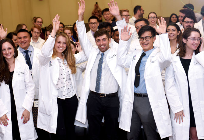 A photo shows participants at the inaugural PhD Lab Coat Ceremony