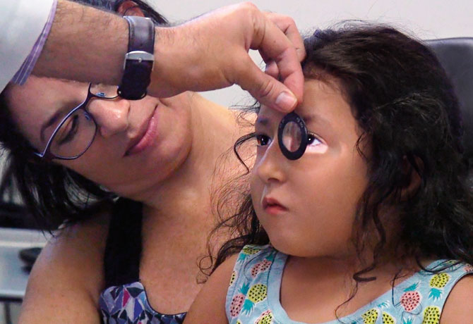 A photo showing a retinoscopy exam.