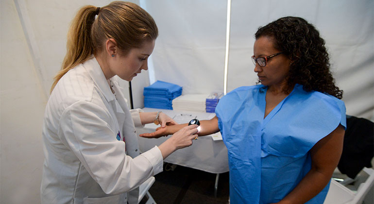 Annette Czernik, MD, performing a skin cancer screening at the Mount Sinai Health Concourse
