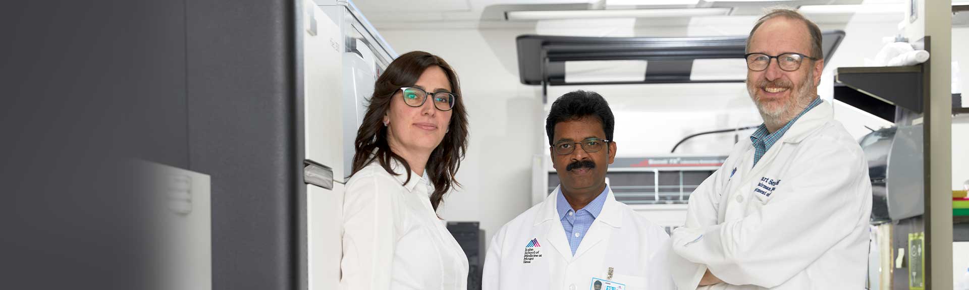 A photo of Principal Investigator Stuart Sealfon, MD, with research team members from the Department of Neurology: Elena Zaslavsky, PhD, Assistant Professor, and Venugopalan Nair, PhD, Associate Professor.