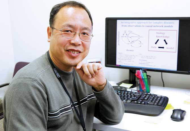 Photo of researcher in front of a computer