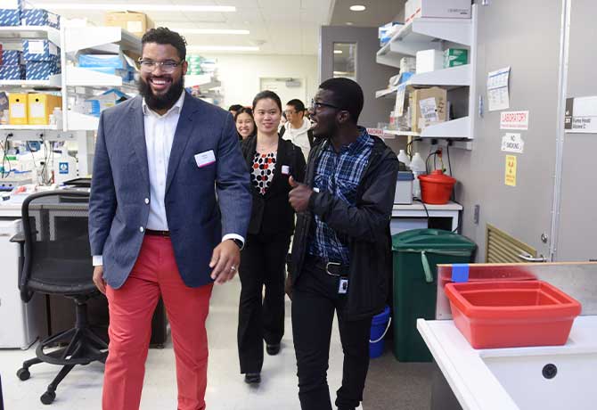 A photo of students from a variety of graduate institutions who presented their research, toured labs and facilities, and met faculty.