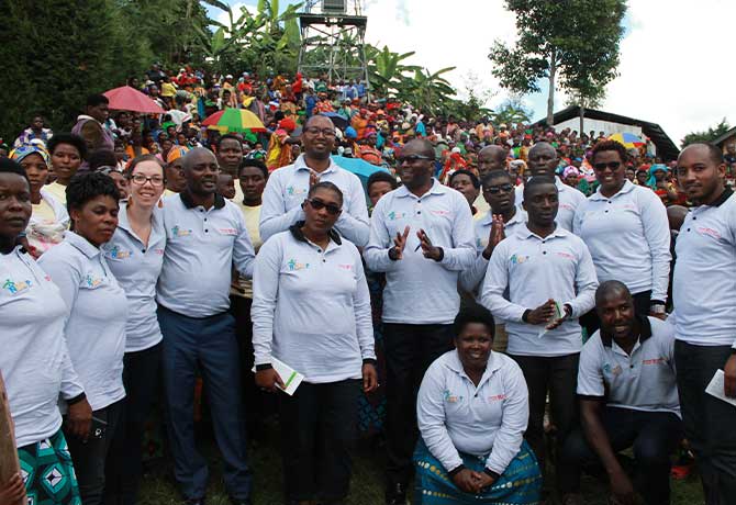 A group photo shows Katie Beck, MPH, who collaborated with government and industry partners to reduce acute malnutrition across Rwanda.