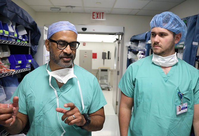 A photo of Student Corey Gill with his mentor, Raj K. Shrivastava, MD