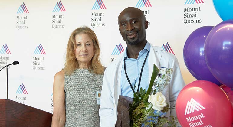 Employee of the Year Rashid Larry, Lead Technician, CT, poses with Caryn A. Schwab, Executive Director of Mount Sinai Queens.