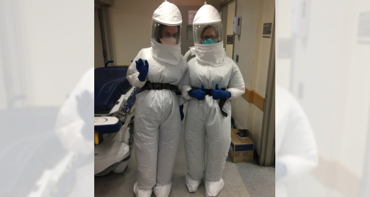 Dr. Fowkes and colleague in PAPR suit