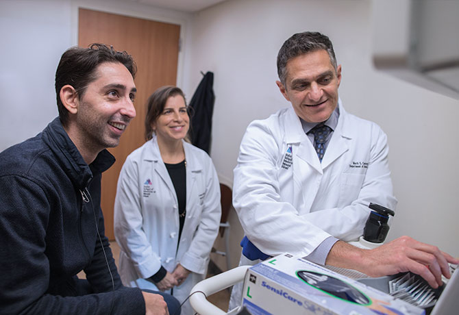 A photo shows Dr. Courey reviewing images with Mr. Bragado-Young and Leanne Goldberg, MS, following the procedure.