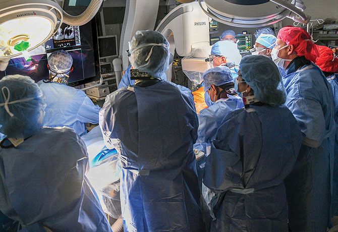 A photo showing David H. Adams, MD, leading a multidisciplinary team performing transcatheter mitral valve replacement.