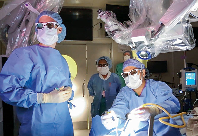 A photo of Joshua B. Bederson, MD, and his team using a surgeon-driven robotic visualization system