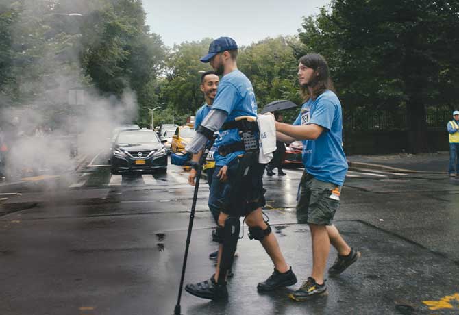 A photo of Peter Schreiner walking to the finish line