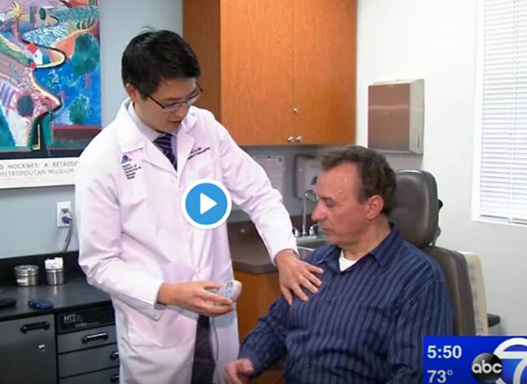 Photo of Doctor touching patient's chest in exam room