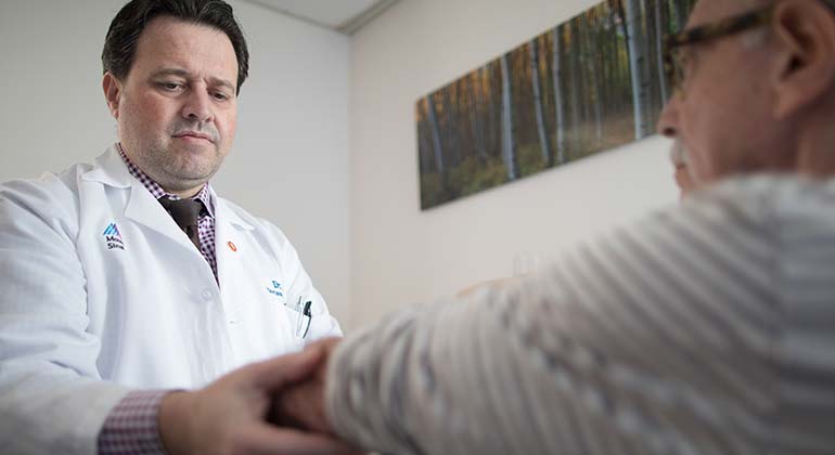doctor holds patient arm
