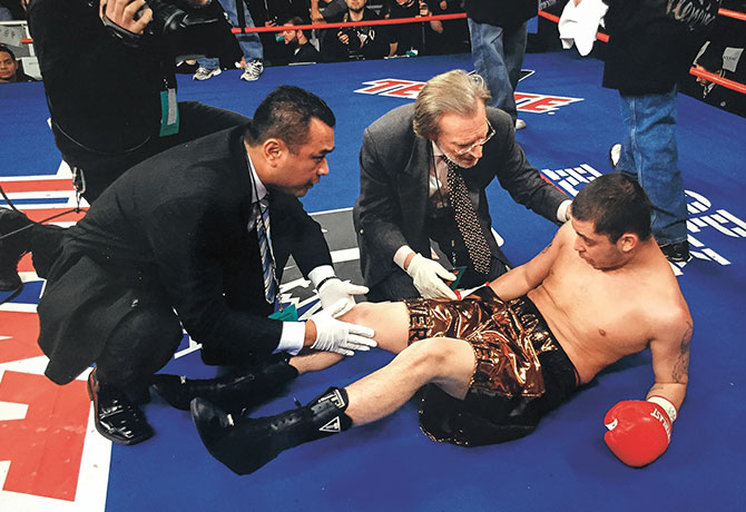Image of Joseph Herrera, DO, evaluating a concussed boxer at Madison Square Garden