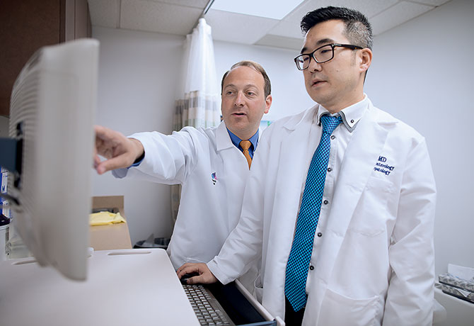 A photo shows Michael S. Smith, MD, and Il J. Paik, MD