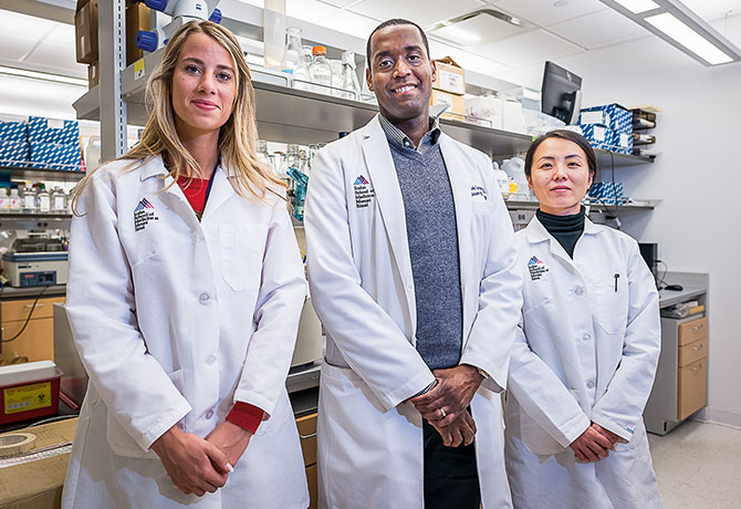 A photo showing Kirk Campbell, MD, Christina Cuttitta and Xiaoxia Yu, MD, PhD