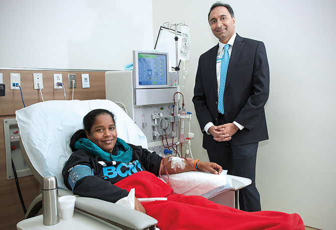 A photo showing Vijay Lapsia, MD and patient Roxanne Holder