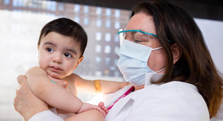 doctor holds Kravis Children Heart Center infant patient