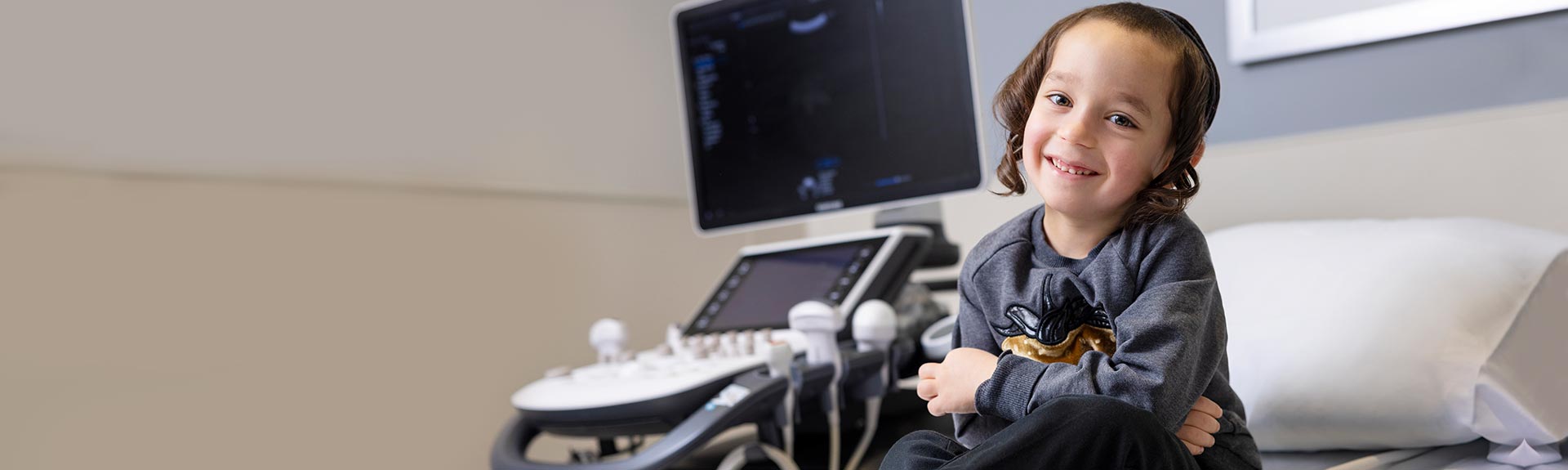 toddler patient, smiling in Kravis Children Heart Center exam room