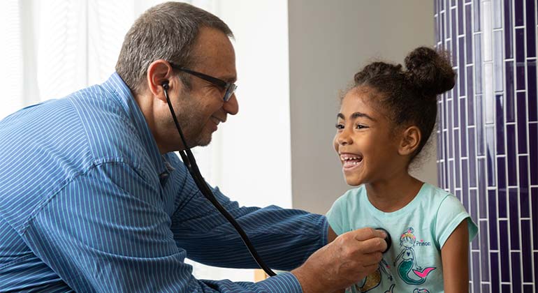 Doctor listening to pediatric patient