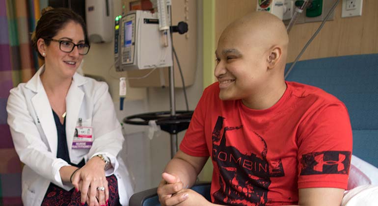 Teenage male patient and mom talking to doctors