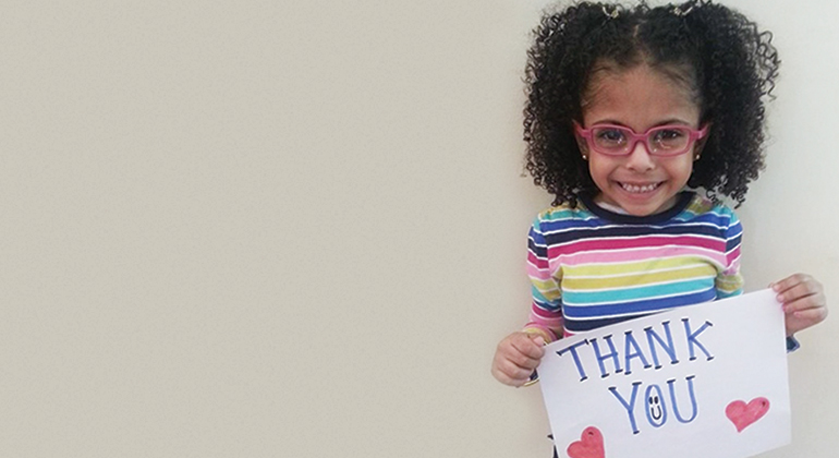 Nephrology patient holding sign saying “Thank you”