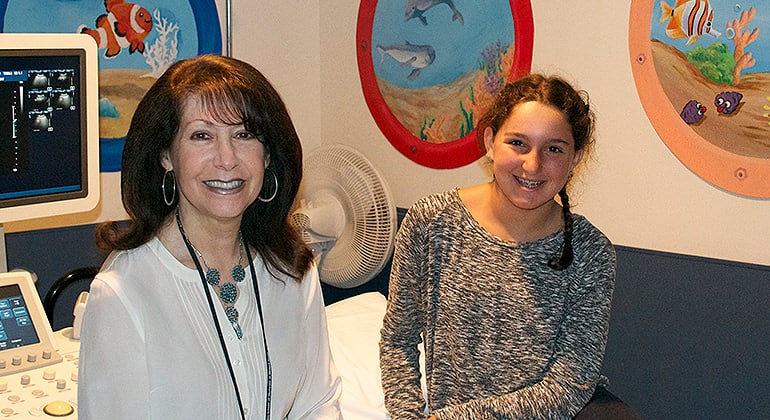 Radiologist and patient in exam room
