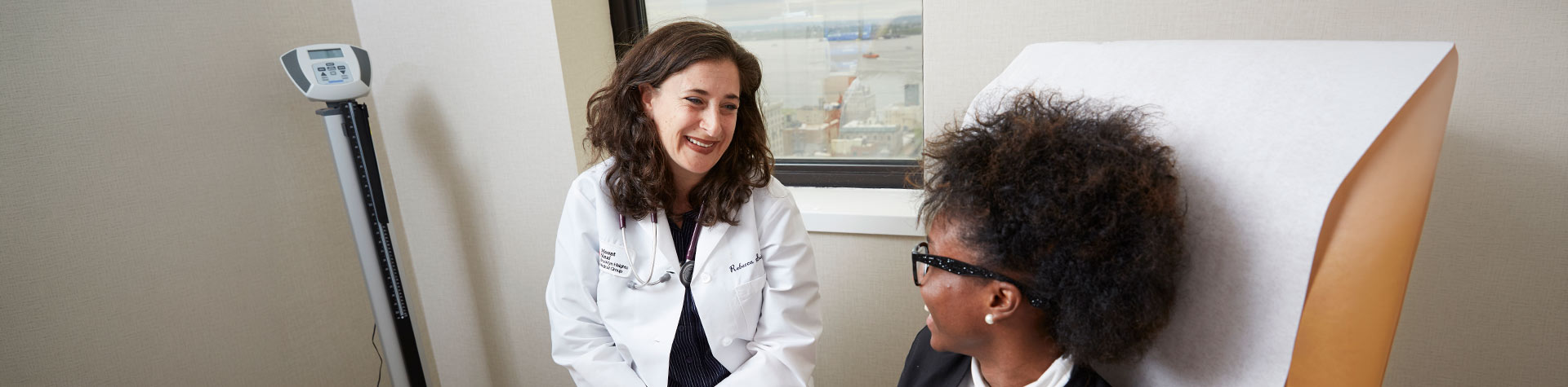 A doctor speaking to a patient in her office