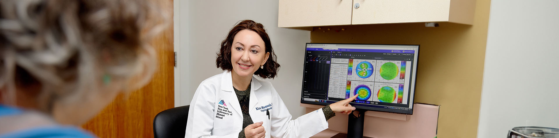 doctor smiling at patient from desk