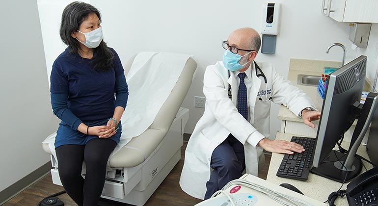 Masked doctor and patient