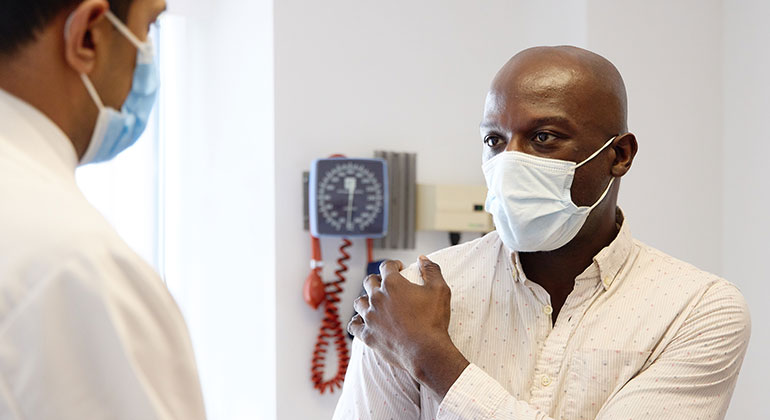 masked patient with doctor